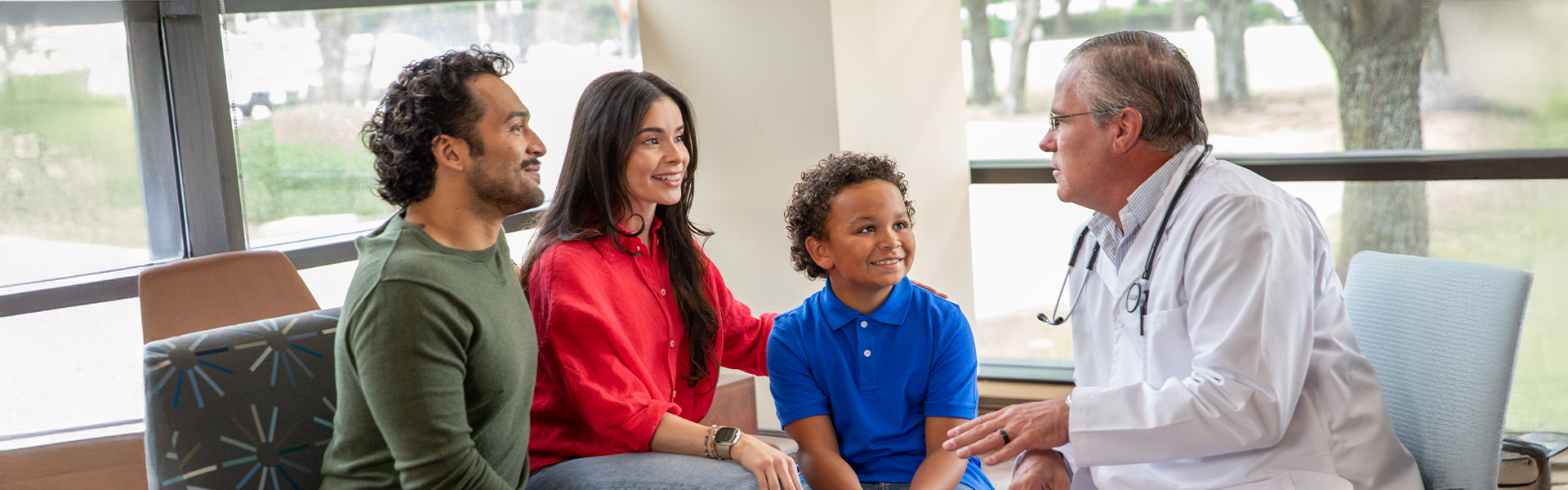 Doctor speaking with family in clinic