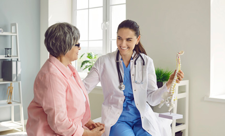 Spine specialist consulting with patient