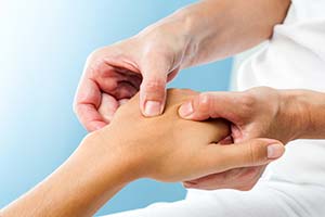 therapist massaging hand