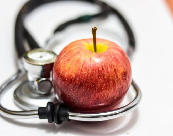 Apple and stethoscope promoting healthy living