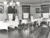 Hospital ward with beds, nurses, and patients